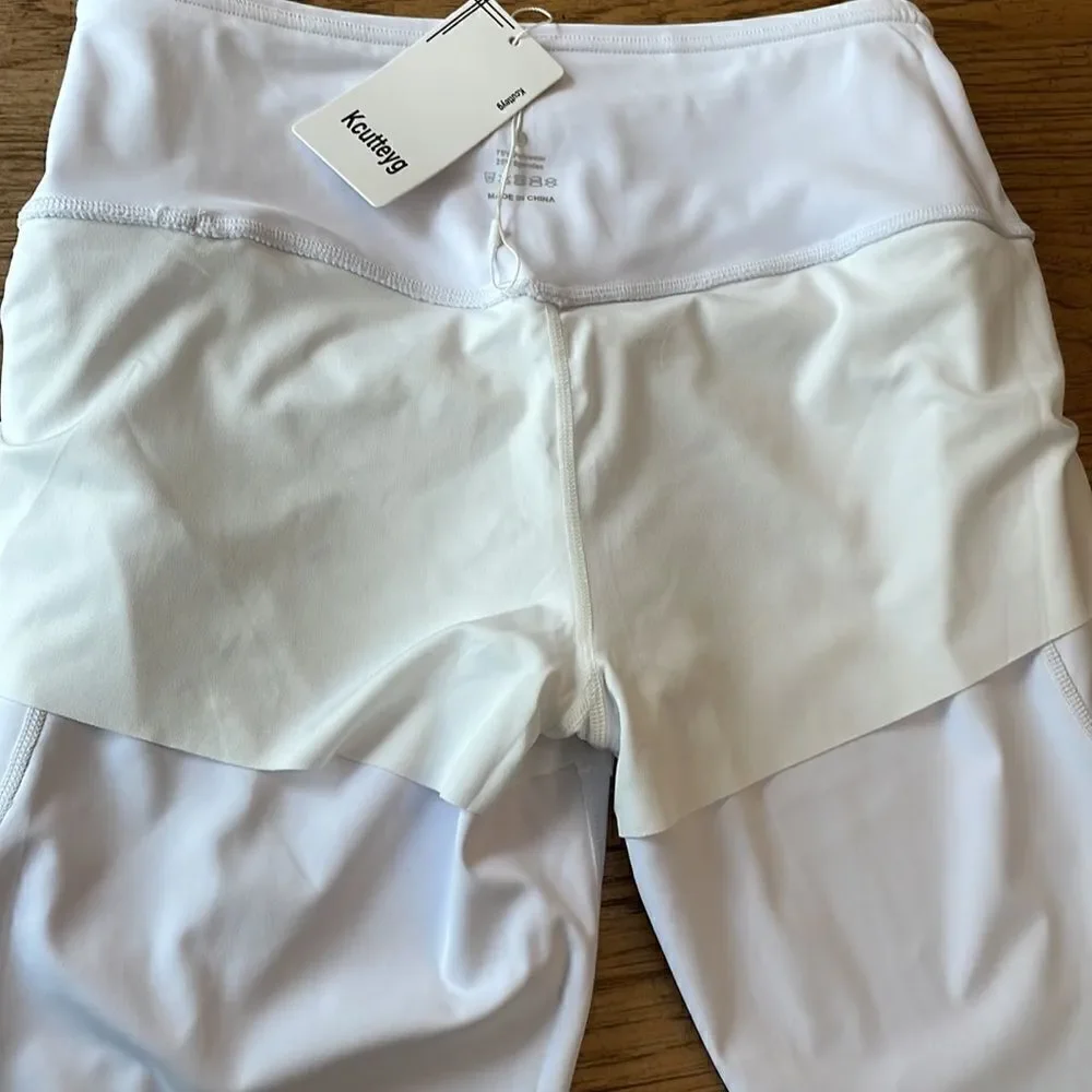 Kcutteyg white exercise capris with side pockets.  New with tags
